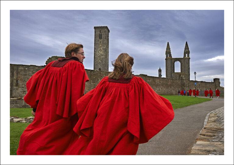 After the pier walk at the start of the Martinmas semester, the biggest walk of the year, undergraduates in traditional red gowns make their way back to town past the cathedral ruins. Gowns are knee-length, made from pure wool with a velvetine collar.